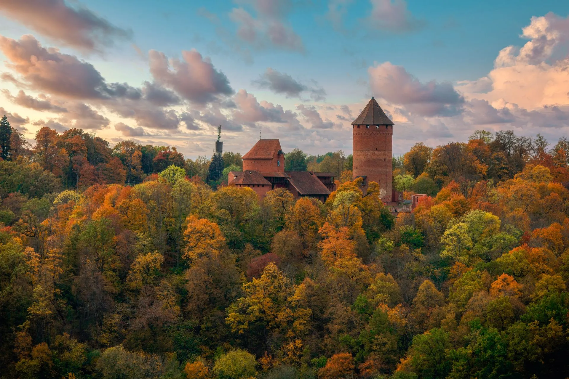 Aerial view of Turaida Castle surrounded by autumn forest in Sigulda, Latvia