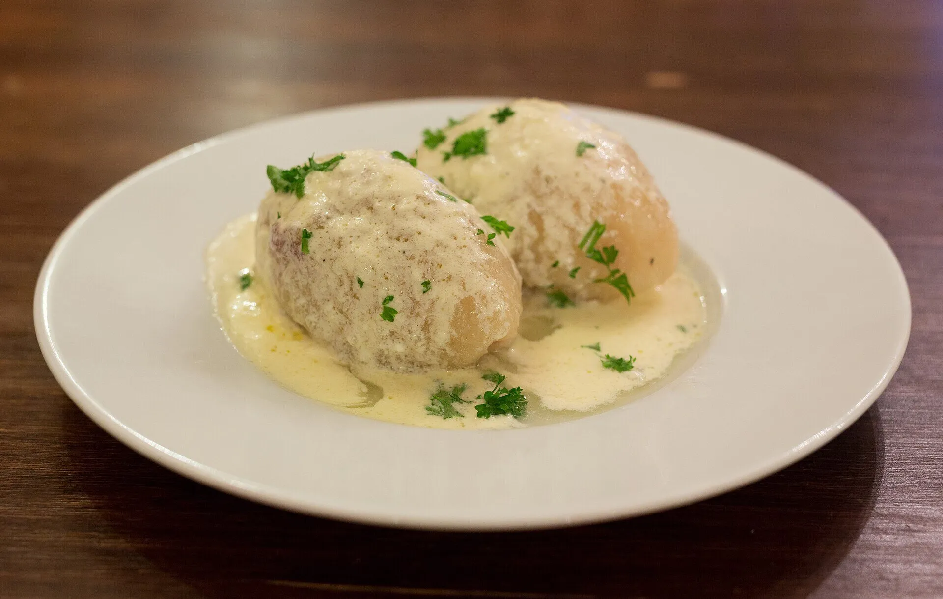 Cepelinai, Lithuania's potato dumplings, served with a cream sauce