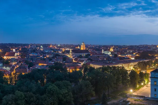 Vilnius Old Town skyline at dusk, with baroque churches and red rooftops